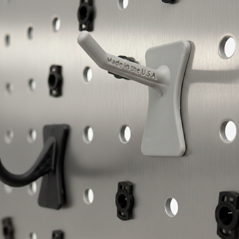 Wall-mounted pegboard with hooks on a gray background